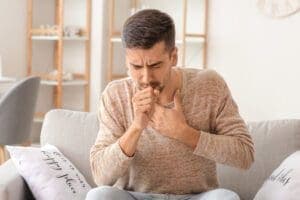 Air conditioning sickness symptoms - coughing man