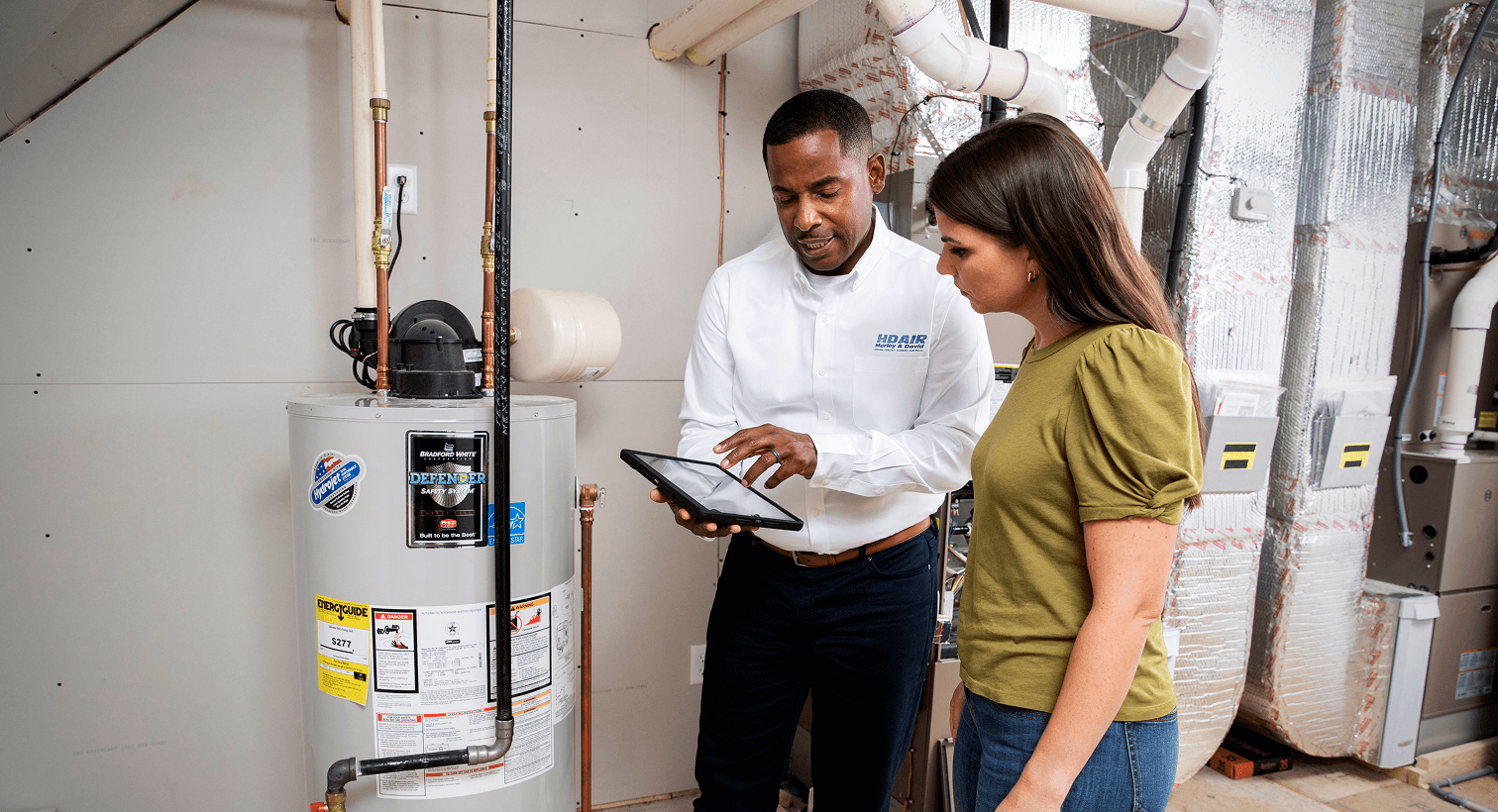 Tech reviewing water heater with client