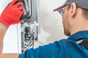 A Hurley & David technician doing hvac unit maintenance