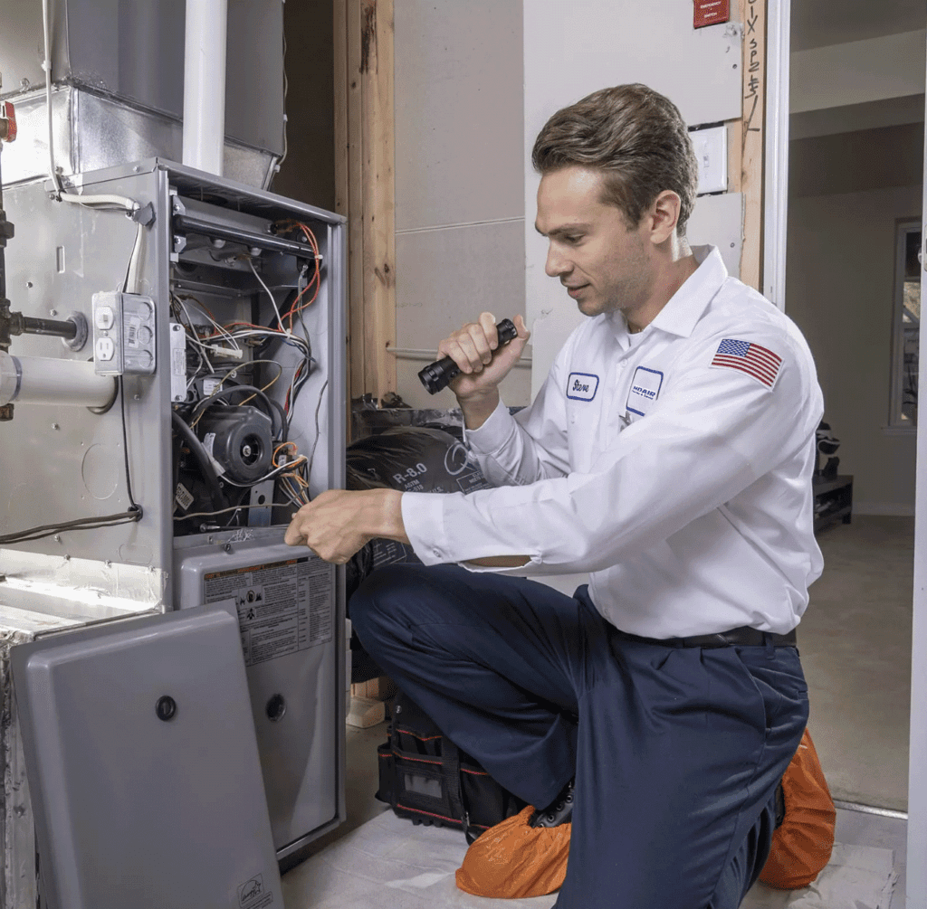 heating technician inspecting a furnace