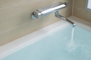 bathtub being filled with hot water from tankless water heater