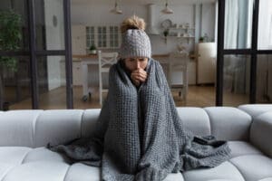 a woman cold in her house because of her short cycling furnace
